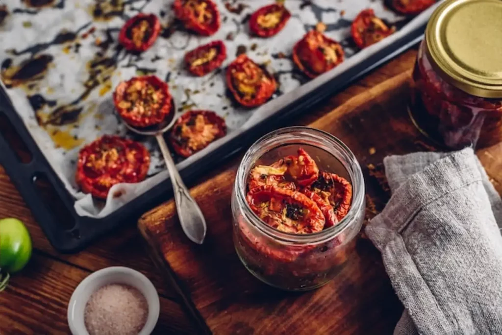 Freshly Oven Baked Tomatoes with Thyme Garlic and Olive Oil Preserved in a Glass Jar