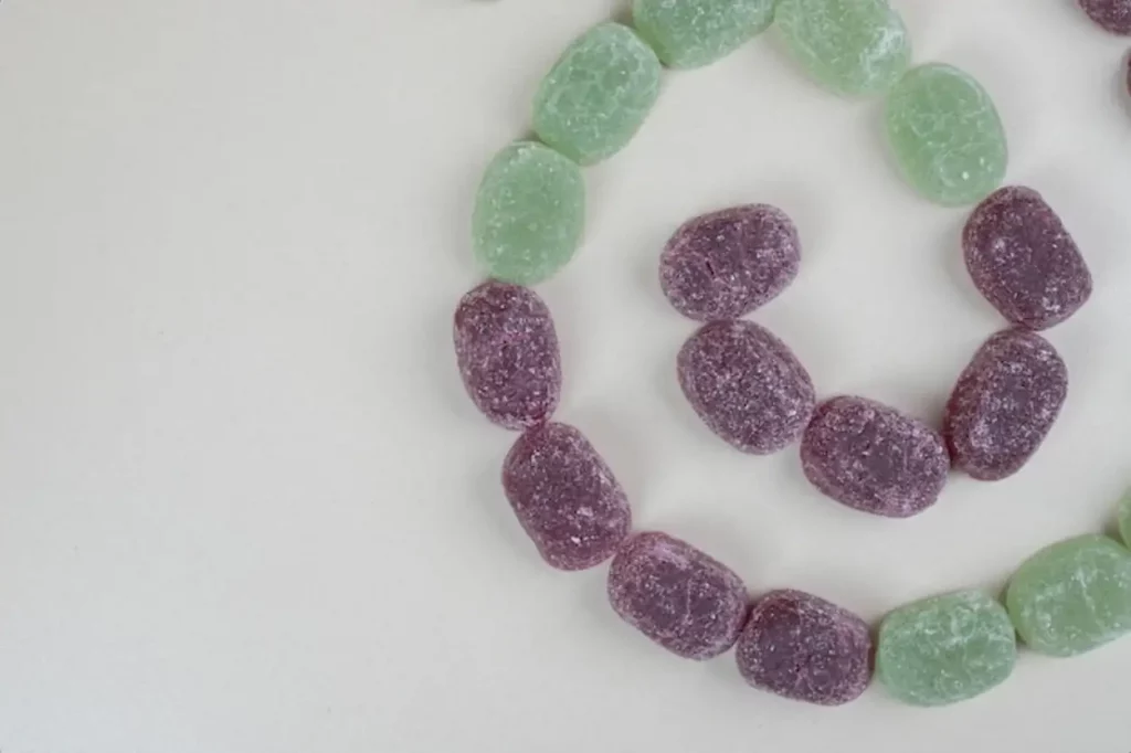 Bunch of tasty jelly candies on beige surface