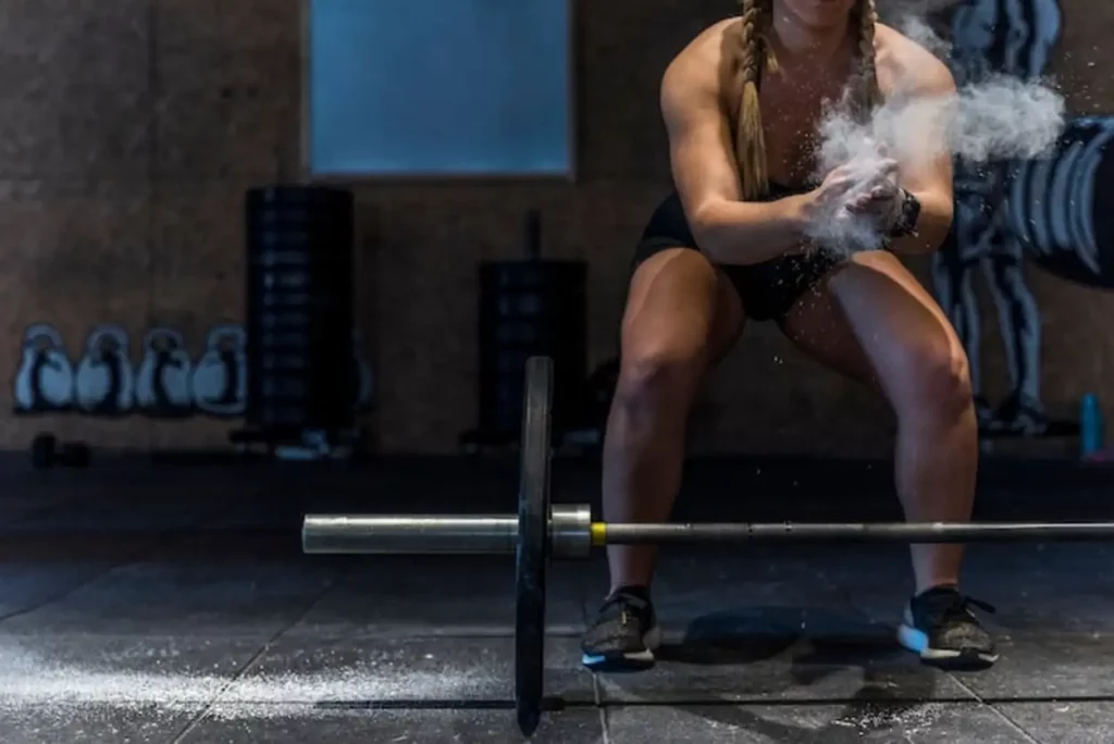 Fitness girl with dust in the hands